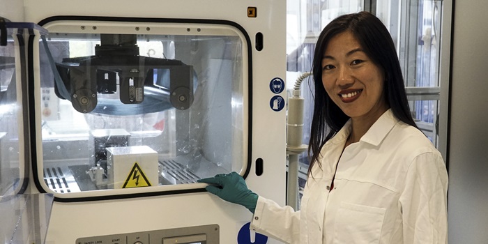 Wenjing (Angela) Zhang in front of the electrospinning equipment at DTU Energy